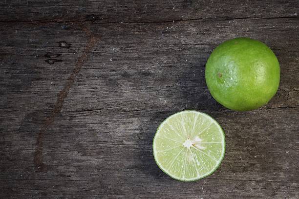 istock Green lime on wood background 2219304296