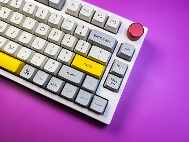 istock Modern mechanical keyboard isolated with red button on purple background. Minimal style and design keyboard. Colorful key cap. 2219304420