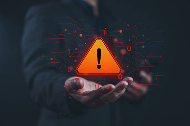 istock System hacked warning alert alarm on laptop. Notification virus of hackercrime, Businessman show icon on hand, Spam virus with warning caution or Malicious software, Spyware, Malicious software. 2219306488