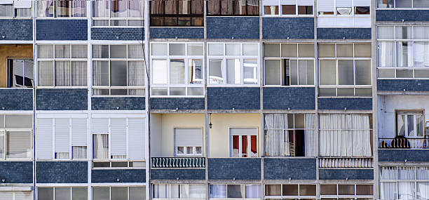 istock Windows of a multi-apartment residential building. 2219308503