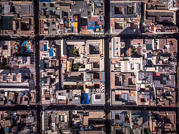 Aerial view of a city grid in Arequipa, Peru, showcasing colorful rooftops and urban layout.