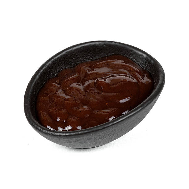 istock A small black bowl filled with glossy, dark brown barbecue sauce, highlighting its rich texture and savory appeal 2219310100