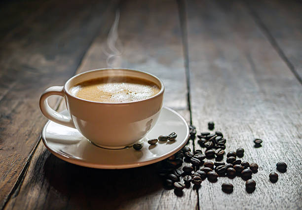 istock Coffee cup and coffee beans on wooden table, Espresso Crema coffee cup aromatic 2219314159