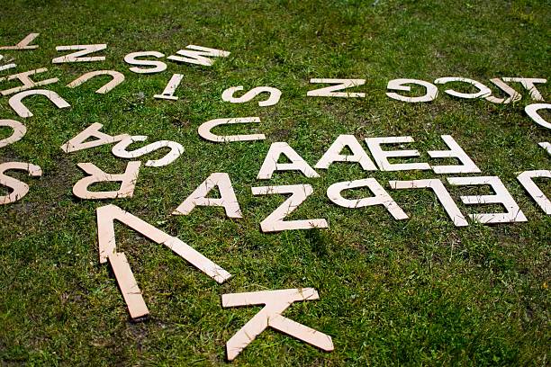 Scattered Wooden Alphabet Letters on Grass
