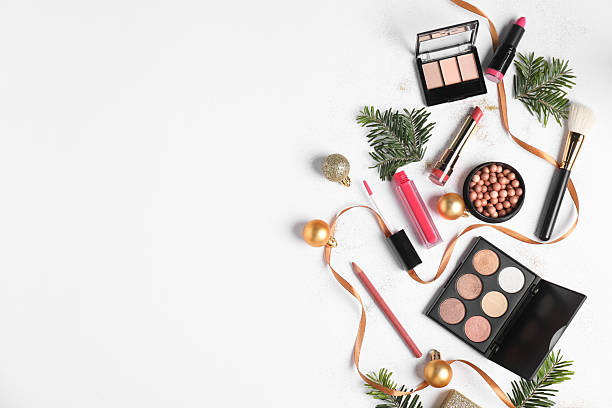 istock Flat lay composition with makeup products and Christmas decor on white background, space for text 2219321015