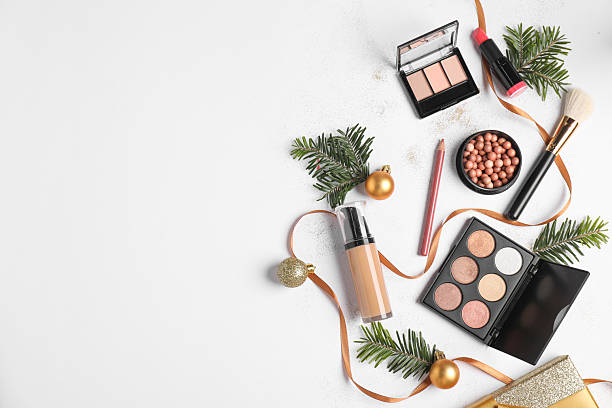istock Flat lay composition with makeup products and Christmas decor on white background, space for text 2219321024