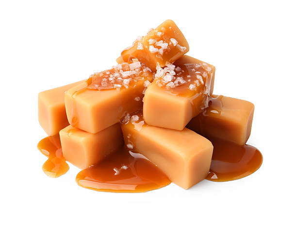 istock Tasty candies with salted caramel isolated on white 2219321425