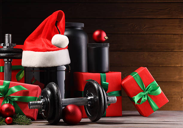 istock Dumbbells, containers with supplement and Christmas decor on wooden table 2219322082