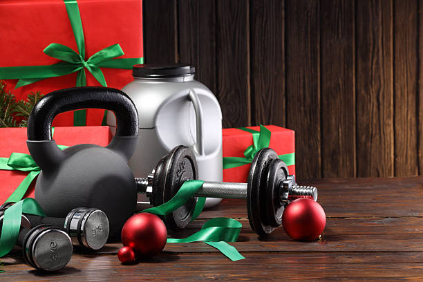 istock Dumbbells, container with supplement, kettlebell and Christmas decor on wooden table 2219322096