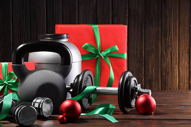 istock Dumbbells, container with supplement, kettlebell and Christmas decor on wooden table 2219322115