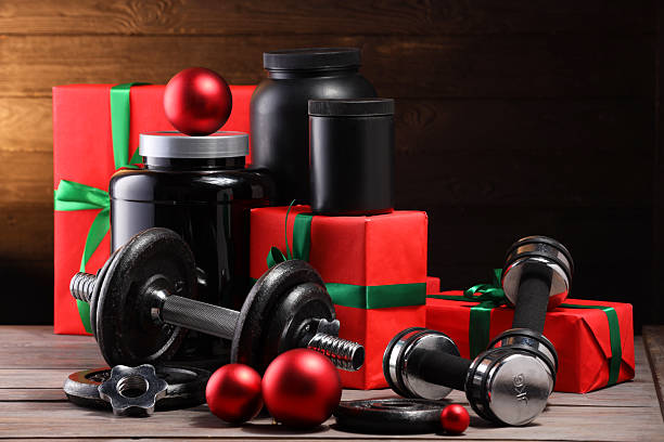 istock Dumbbells, containers with supplement and Christmas decor on wooden table 2219322191