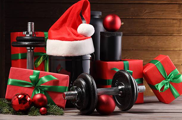 istock Dumbbells, containers with supplement and Christmas decor on wooden table 2219322201
