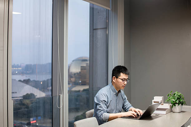 istock The man is working overtime with laptop in the office at night 2219322418