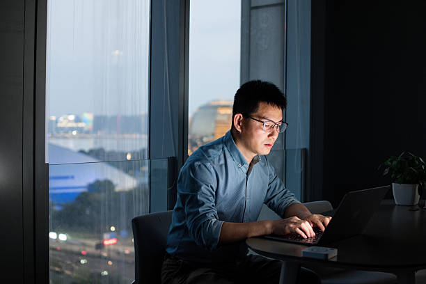 istock The man is working overtime with laptop in the office at night 2219322607