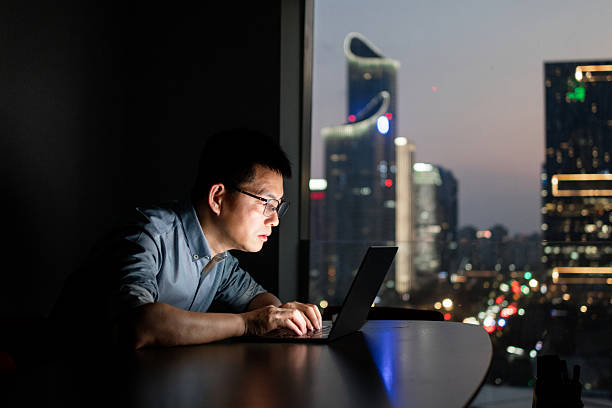 istock The man is working overtime with laptop in the office at night 2219322621