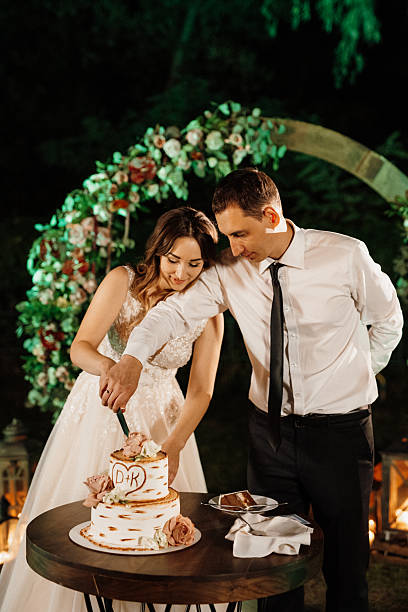 istock newlyweds happily cut and taste the wedding cake 2219323078