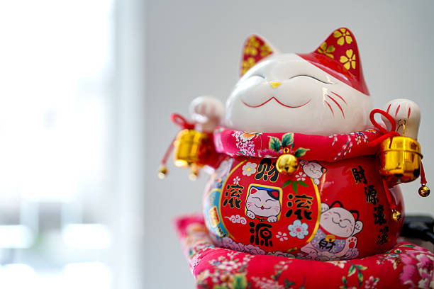 istock Smiling Maneki Neko Figurine with Floral Red Outfit 2219323082