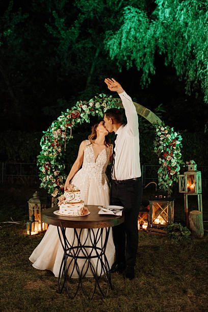 istock newlyweds happily cut and taste the wedding cake 2219323306