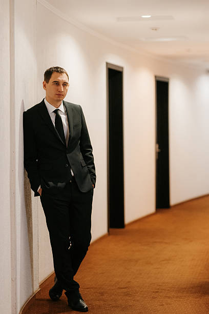 istock portrait of a young guy in a black suit 2219323885
