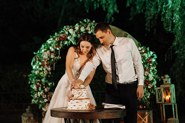 istock newlyweds happily cut and taste the wedding cake 2219323937