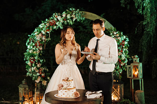 istock newlyweds happily cut and taste the wedding cake 2219324621