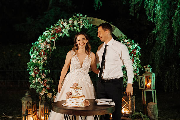 istock newlyweds happily cut and taste the wedding cake 2219325001