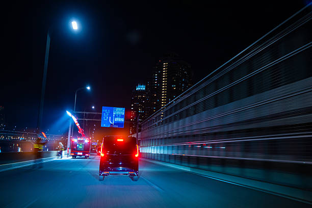 Tokyo Night Drive Along the Waterfront with working crew vehicle