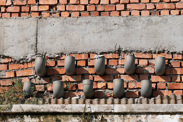 Clay vase displayed on a stone wall shelf