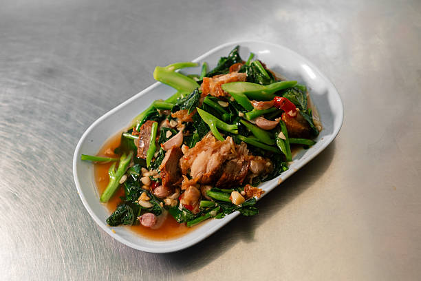 Sautéed pork loin with Eryngii Mushroom on plate on white background