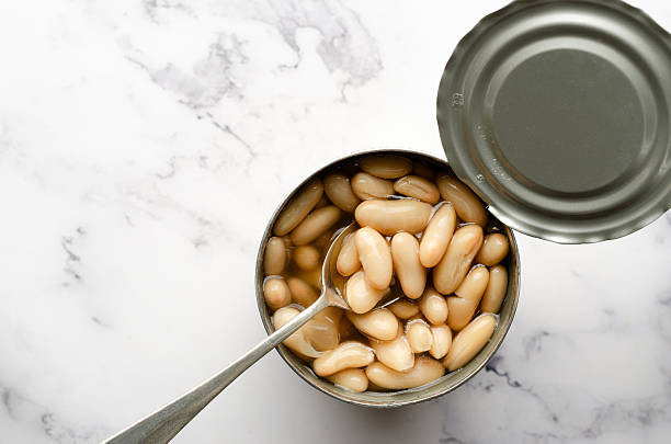 Top view of a spoon in a can of white beans with copy space.