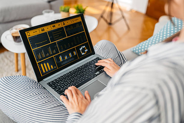 istock Young Woman Working On A Laptop While Sitting On The Sofa At Home 2219328074