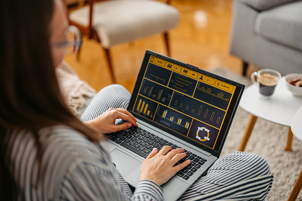istock Young Woman Working On A Laptop While Sitting On The Sofa At Home 2219328130