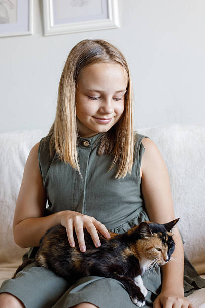 istock Adorable child and her cat pet at home 2219328338