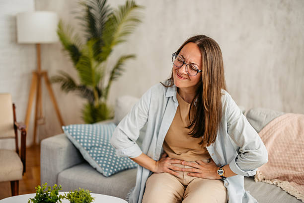 istock Young Woman Having A Stomachache At Home 2219328598