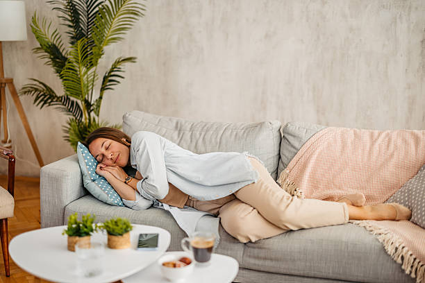 istock Young Woman Sleeping On The Sofa At Home 2219328694