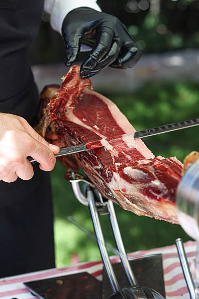 Traditional cut of Iberian ham with a knife