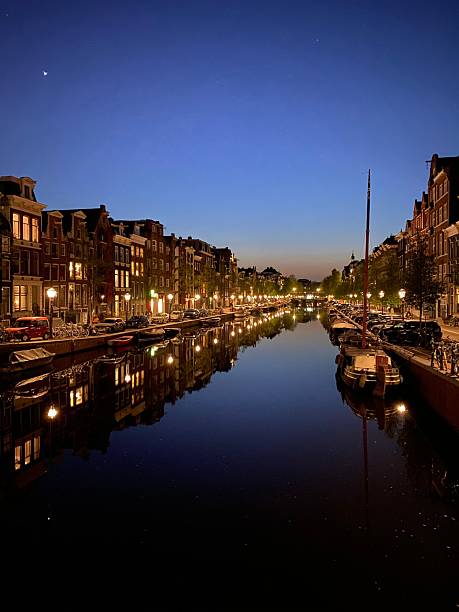 istock Evening view of Amsterdam canal with reflections. 2219331189