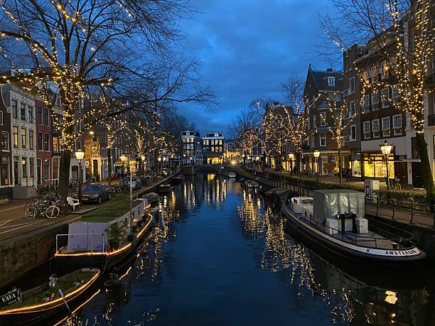 istock Amsterdam canal at dusk with festive lights. 2219331191
