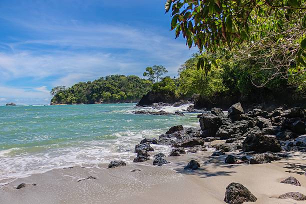 istock Scenic tropical beach with rocky shoreline and lush greenery. 2219331393