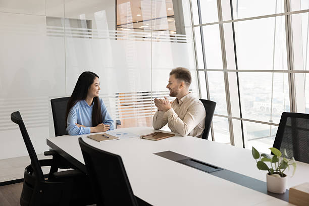 istock Multiethnic friendly teammates talking met in contemporary boardroom 2219332086
