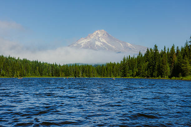 Majestic landscape of alpine lake with pine forest and background view of mt Hood in morning fog, Oregon state