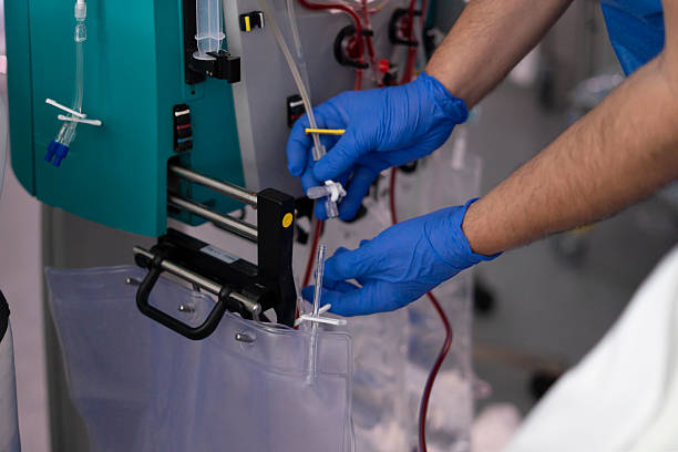 istock Doctor using dialysis machine preparing blood transfusion bag in hospital 2219333114