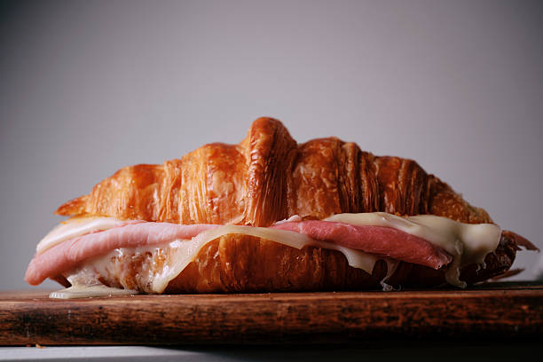 istock Warmed sliced croissant filled with melted cheese and ham. 2219334875