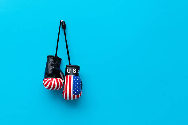 Boxing glove with American flag on blue background.