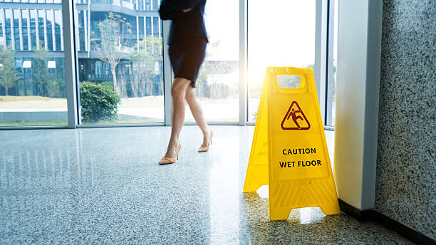 istock Caution wet floor sign with motion blurred legs walking 2219335635
