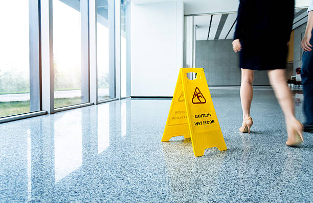 Caution wet floor sign with motion blurred legs walking