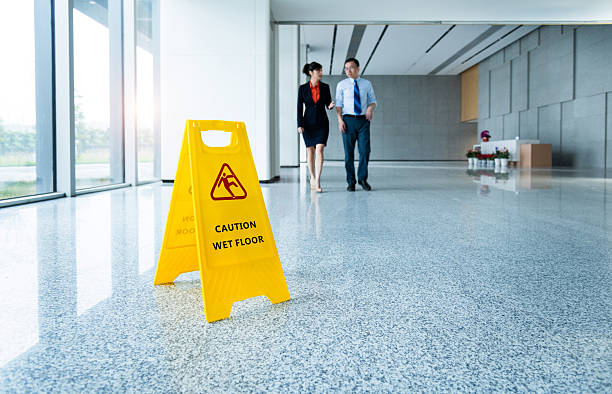 istock Caution wet floor sign with businessmen walking 2219335810