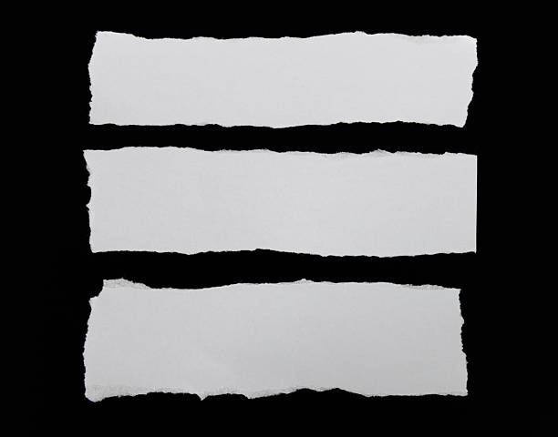 istock Pieces of torn paper on black background 2219335813