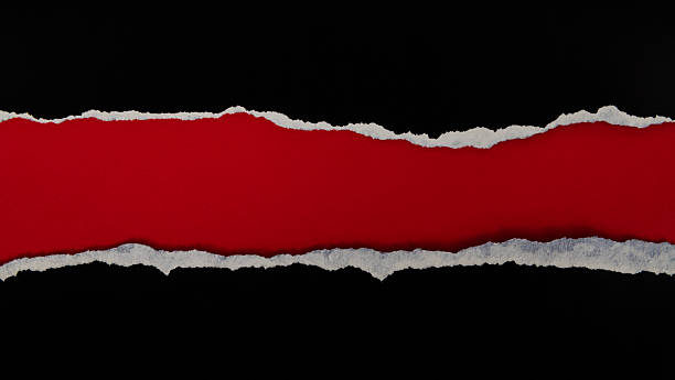 istock Torn black paper revealing red space 2219335835