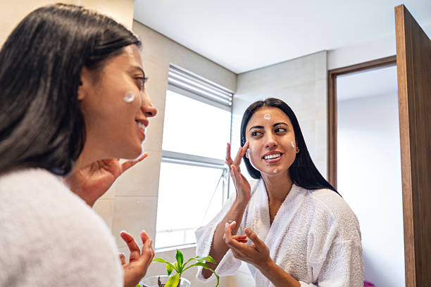 istock Woman applying moisturizing face cream during home beauty routine 2219337184